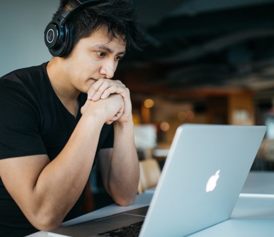 Coursera’s Impressive IPO Causes its Stock to Rise Man doing schoolwork on his laptop