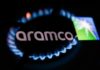 Flames from a gas burner and Aramco logo displayed on a phone screen